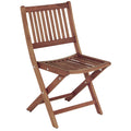 Whitecap teak folding chair with oiled finish and brass hardware, open and ready for use